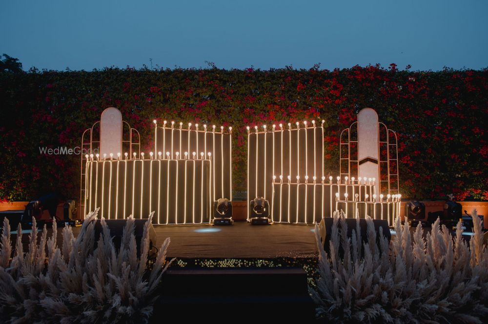 Photo of Unique stage decor with vertical lights and pampas grass