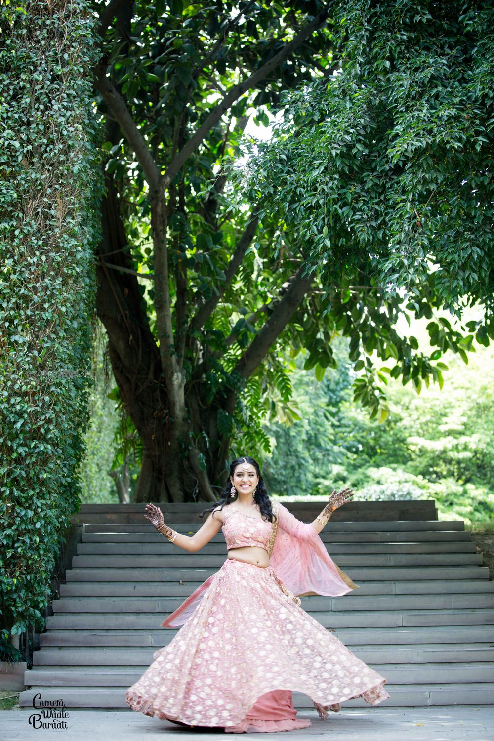 Photo of A bride in a light pink lehenga for her mehndi