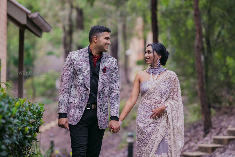 Photo of couple portrait in coordinated lavender outfits for welcome dinner