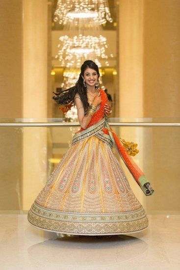 Photo of yellow orange and green bridal lehenga