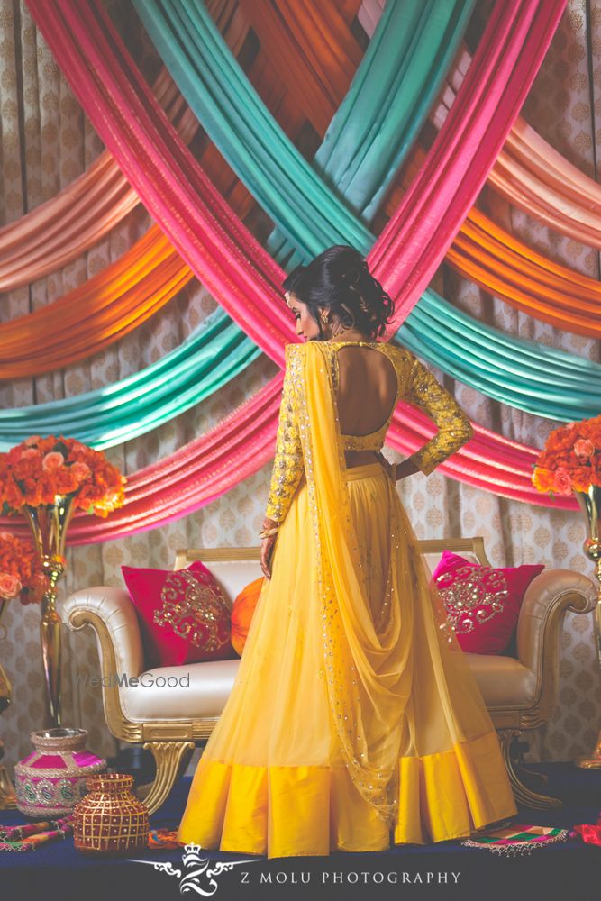 Photo of Bridal back with full sleeved yellow lehenga