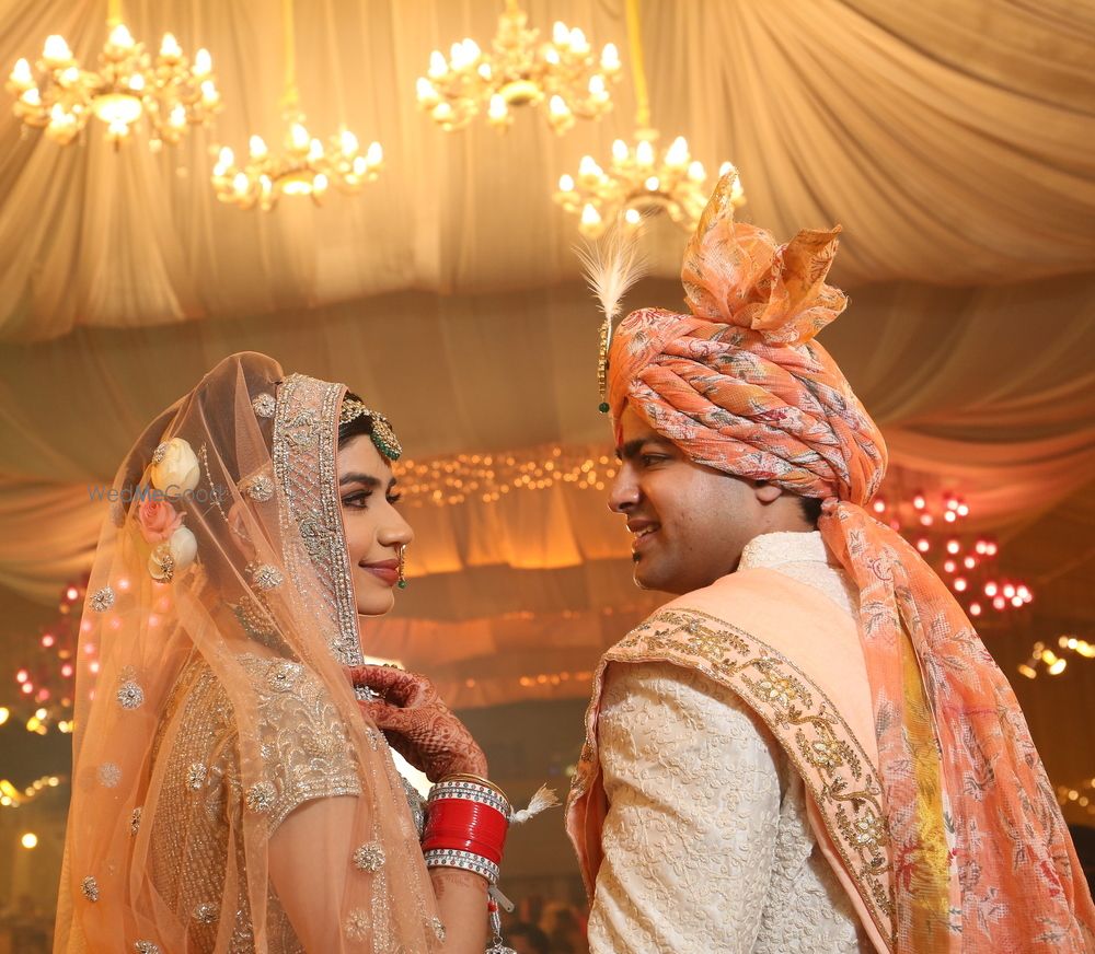 Photo of Orange floral safa for groom