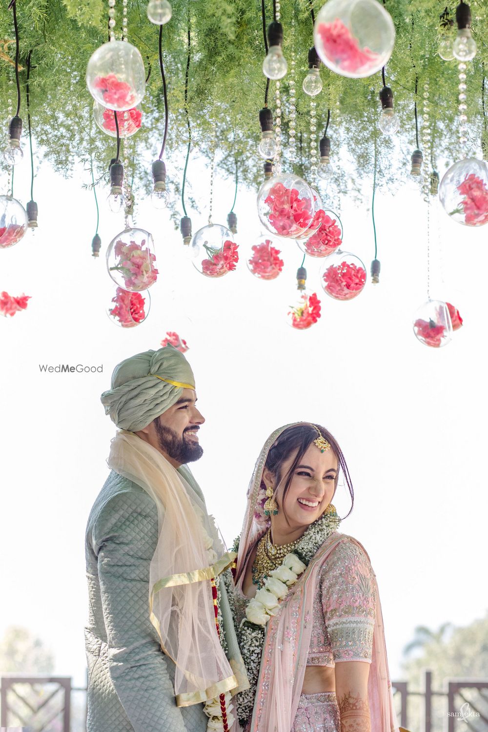 Photo of Candid shot of a couple smiling in between the rituals.