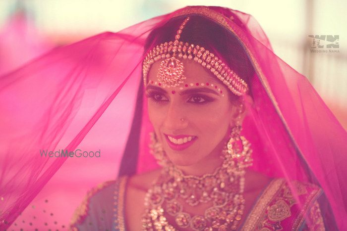 Photo of bride with fuschia pink veil