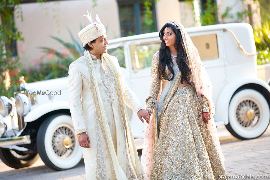 Photo of Bride and groom holding hands