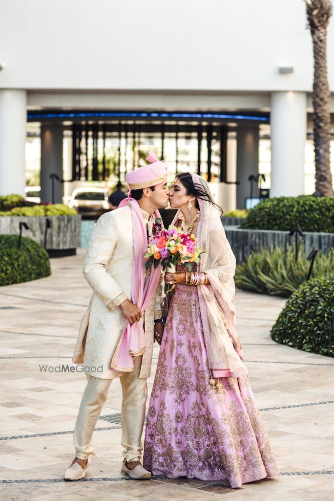 Photo of Pastel bride and groom kissing shot