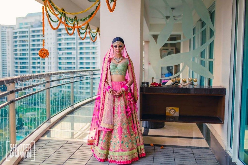 Photo of Mint and bright pink bridal lehenga