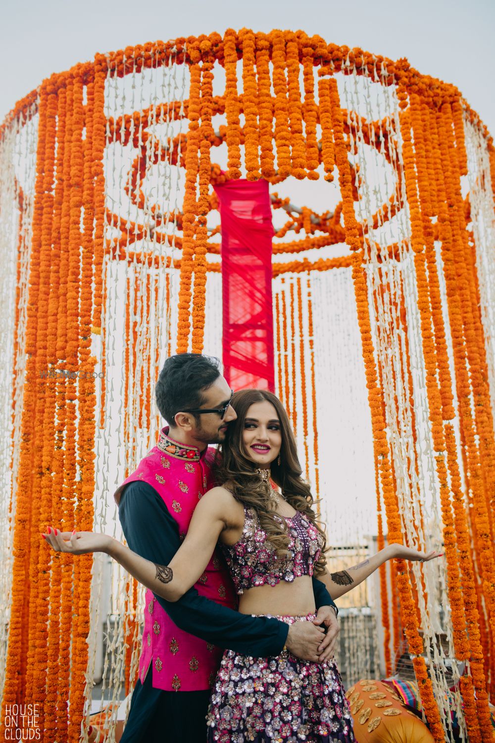 Photo of Mehendi couple portrait against genda phool photobooth