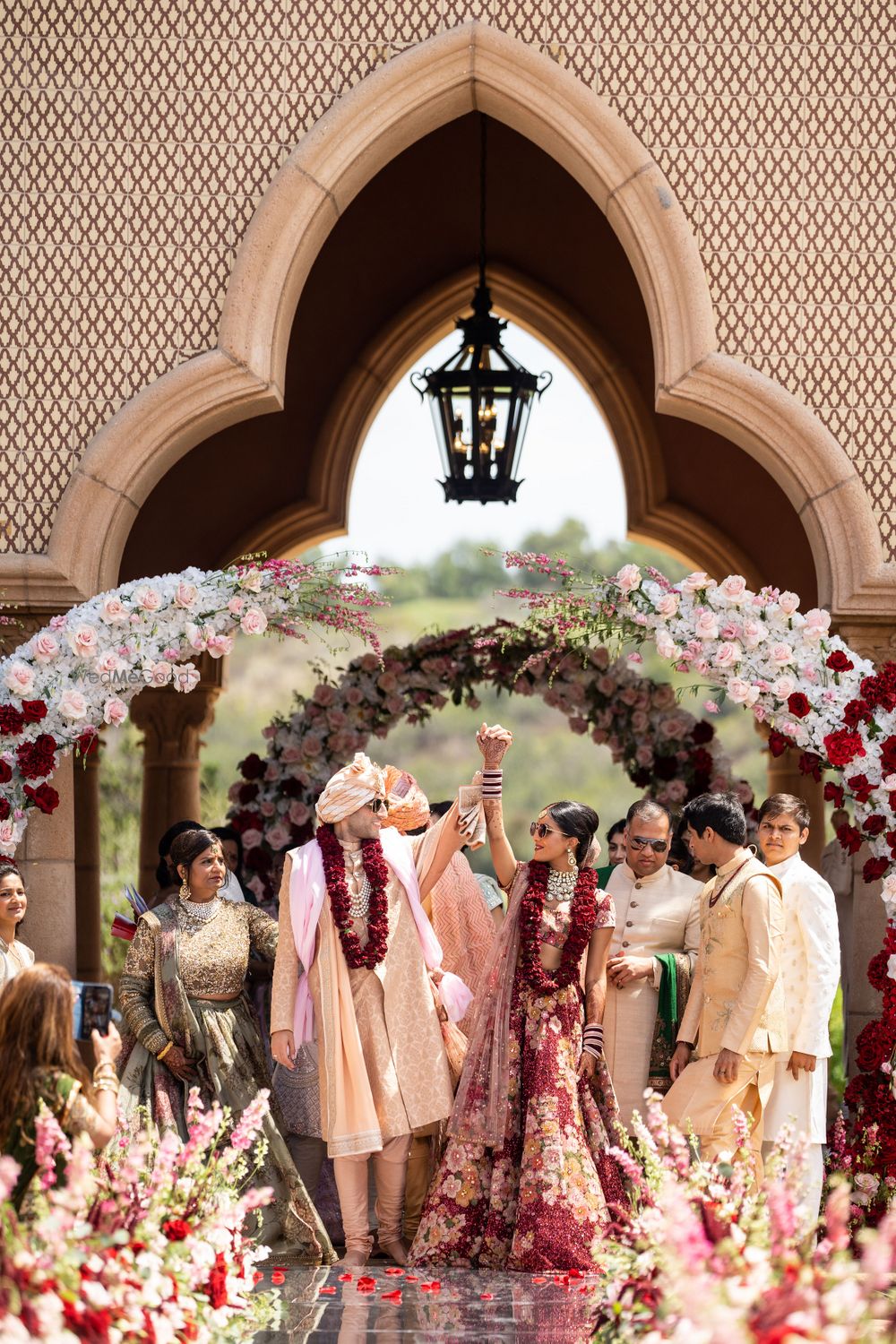 Photo of cute couple shot post pheras with bride and groom wearing sunglasses