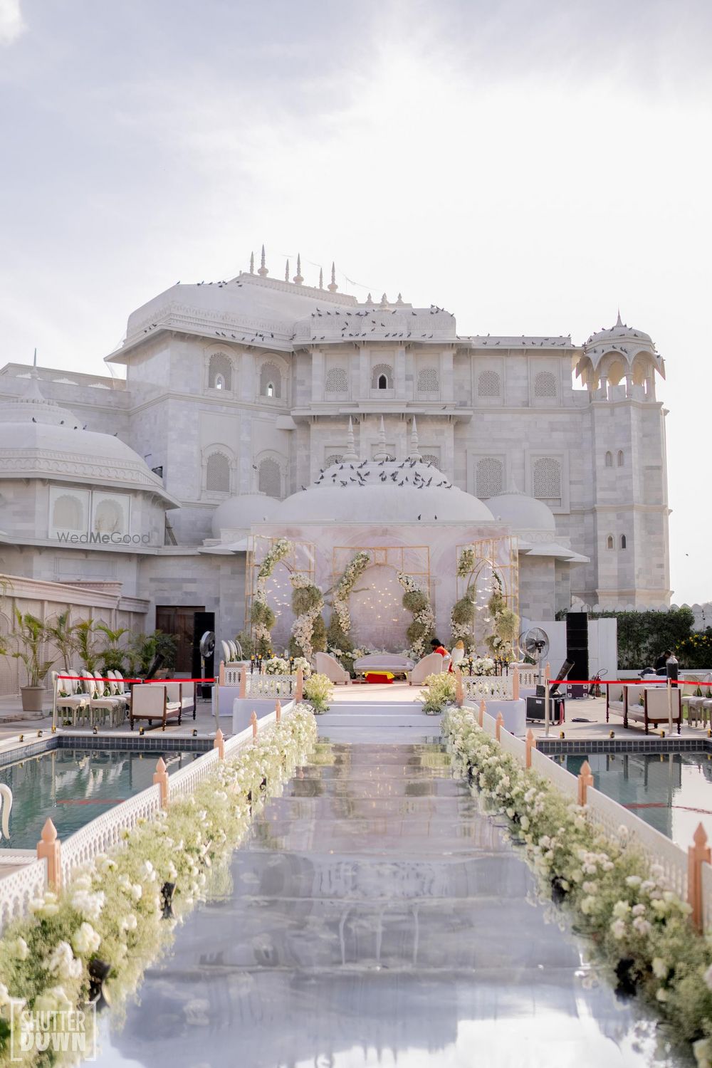 Photo of Stunning all white mandap decor at a palace venue