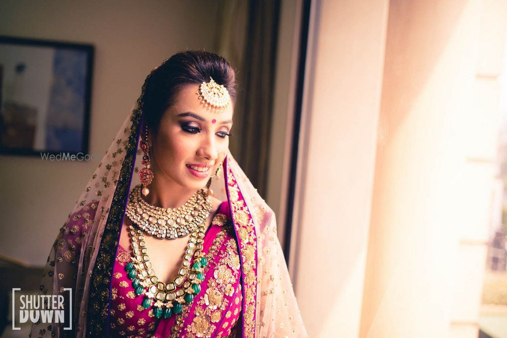 Photo of Pink and purple bridal portrait