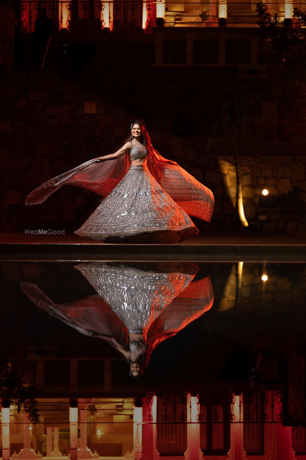 Photo of twirling shot of bride in stunning silver lehenga