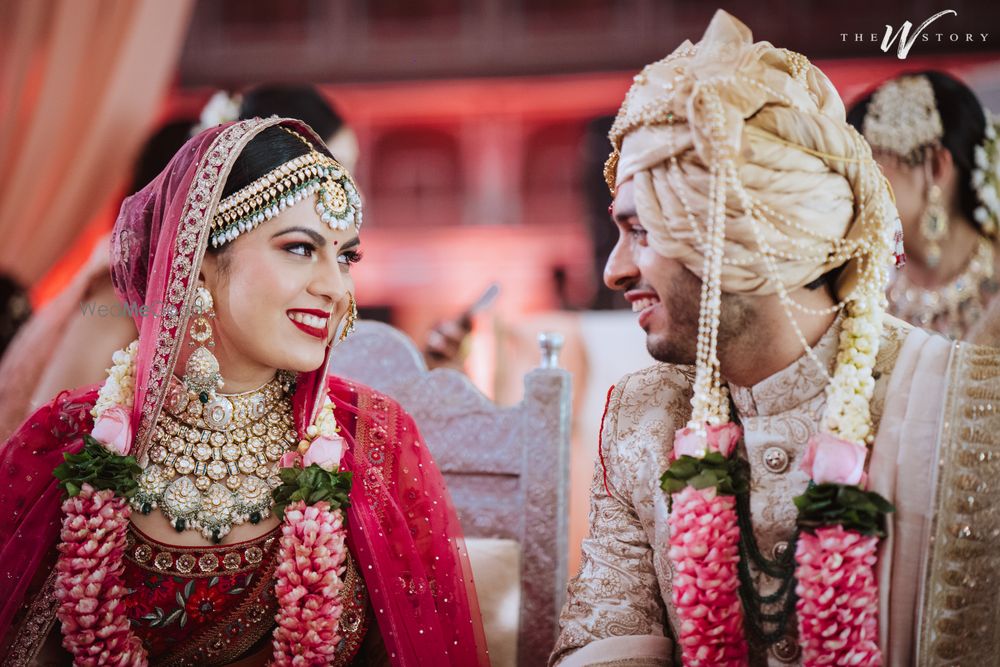 Photo of Candid shot of bride and groom looking at each other.