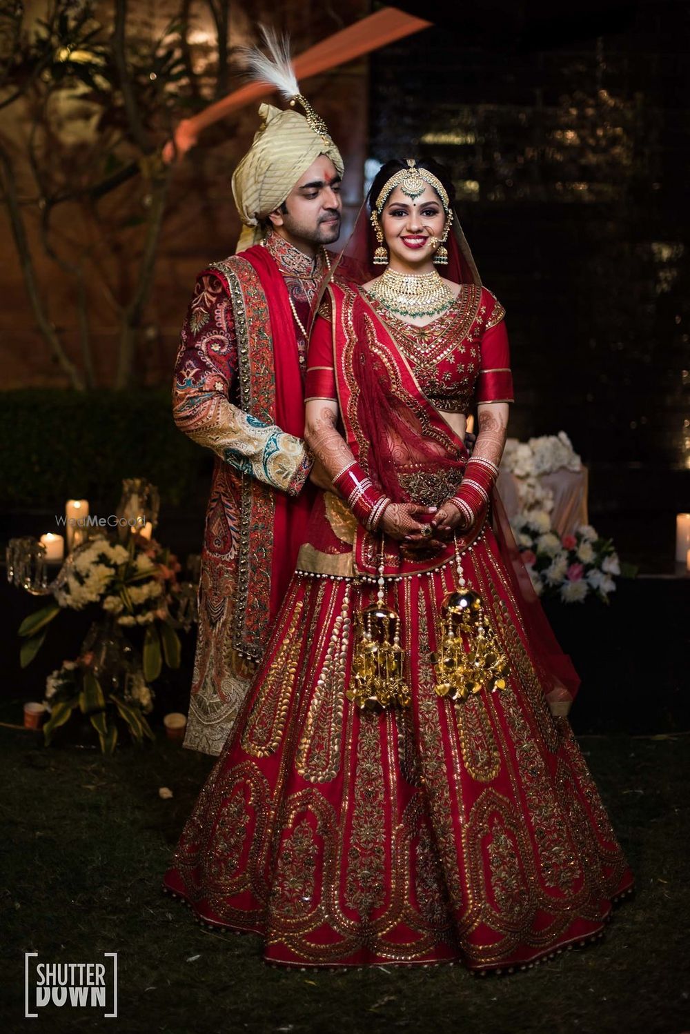 Photo of Matching bride and groom in red outfits