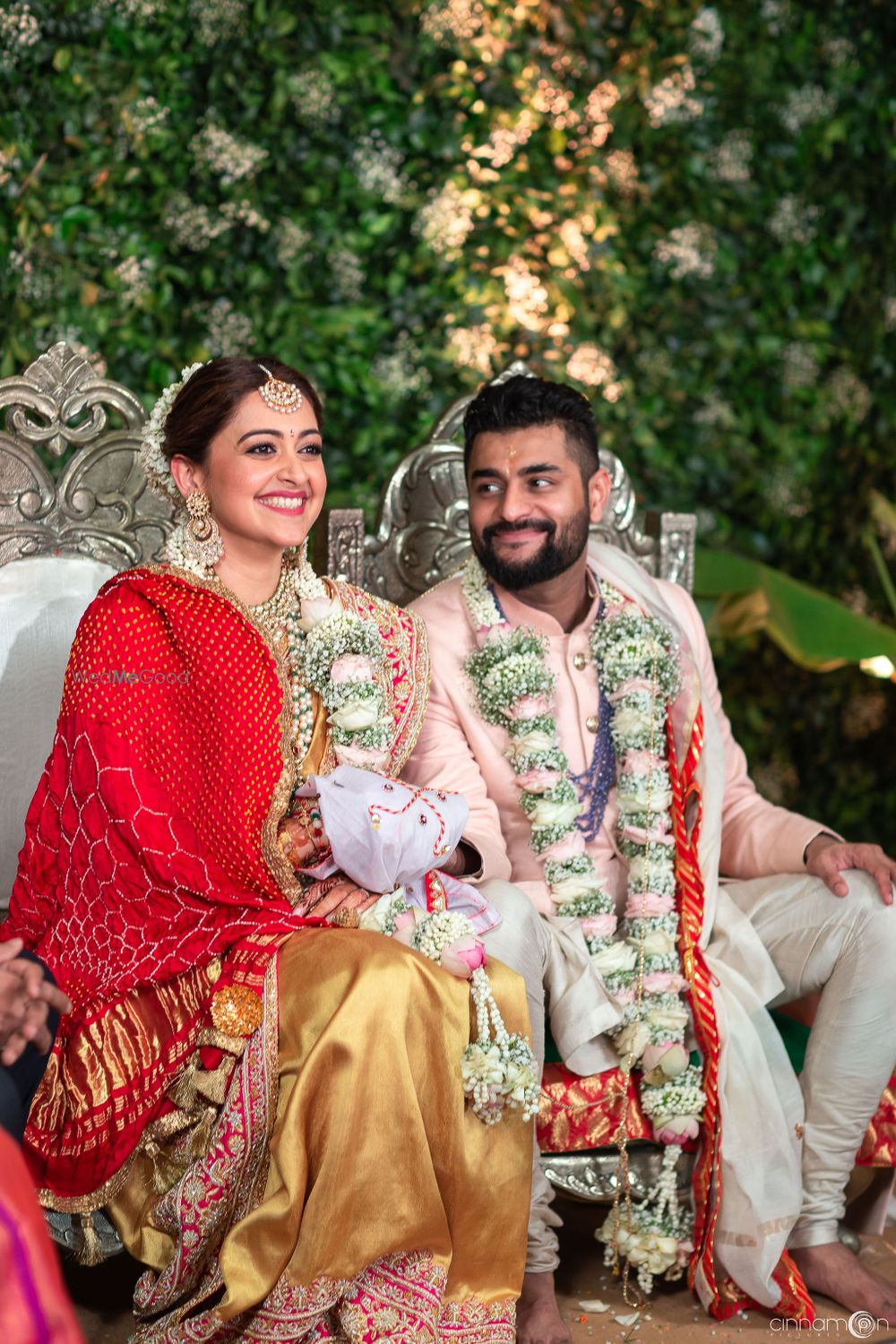 Photo of Happy couple wearing unique babys breath jaimala