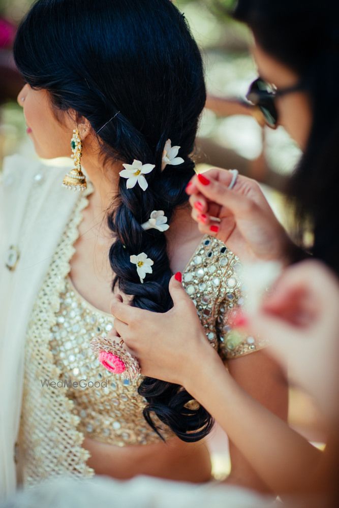 Photo of Braided flower hairstyyle with white flowers