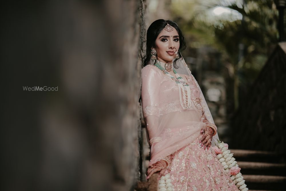 Photo of bridal portrait with floral kaleere and green jewellery with pastel lehenga