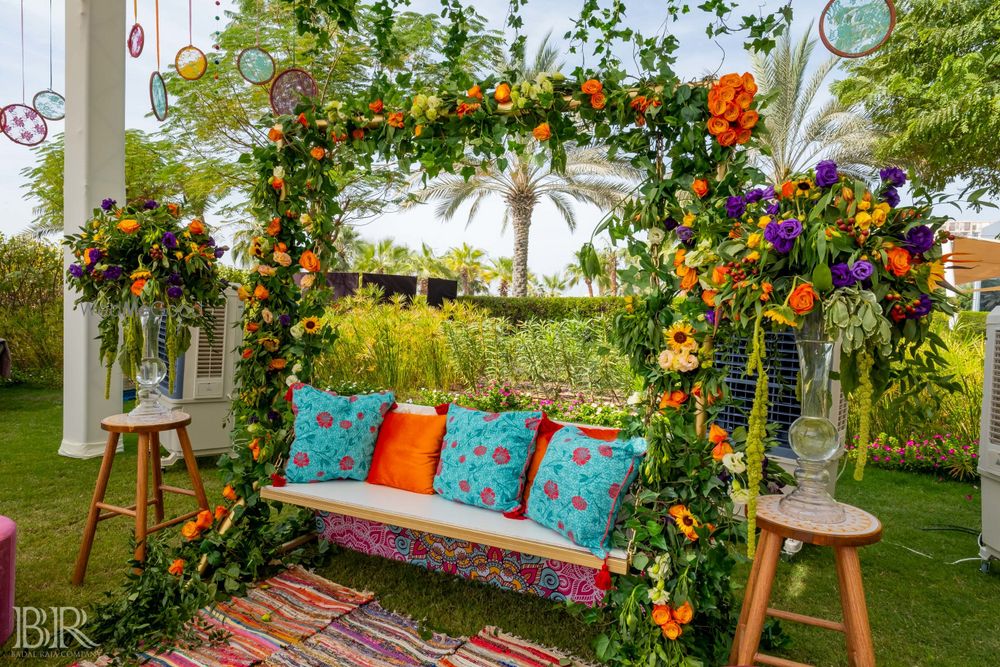 Photo of Mehendi decor with cushions on swing