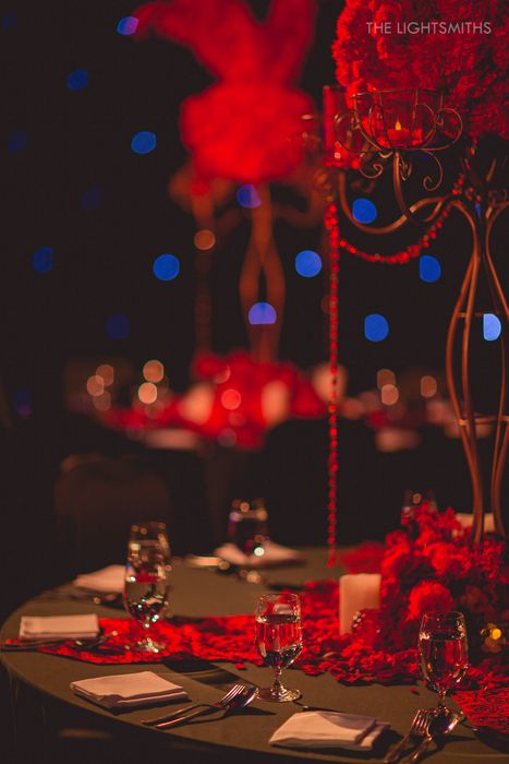 Photo of black and red table centerpieces for sangeet moulin rouge theme