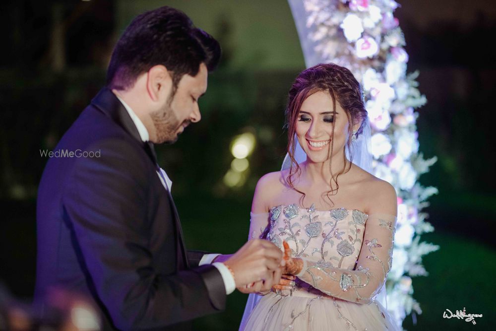 Photo of bride on engagement in off shoulder gown and unique hairdo