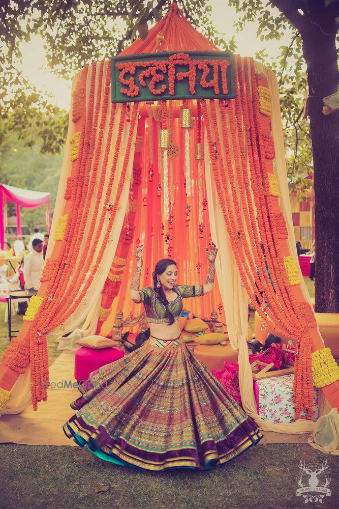 Photo of Printed mehendi lehenga bride twirling