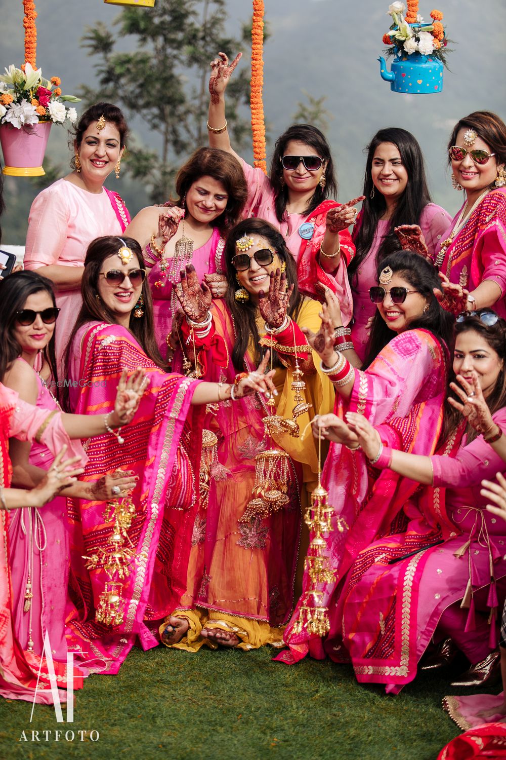 Photo of Bride showing off kaleere with bridesmaids photo