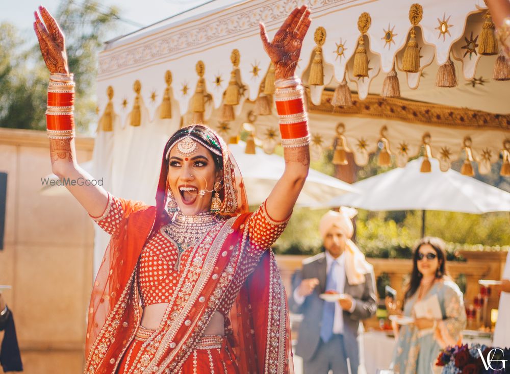 Photo of Bride in red looking radiant and happy