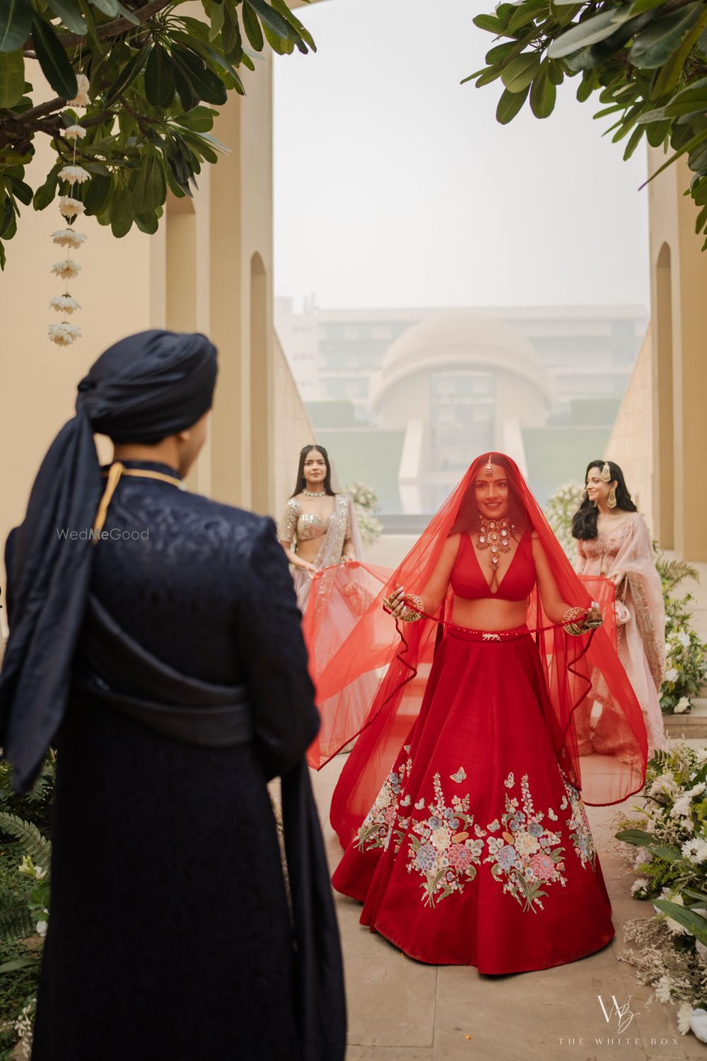 Photo of Classic bridal entry shot with the bride entering under a sheer veil along with her bridesmaids