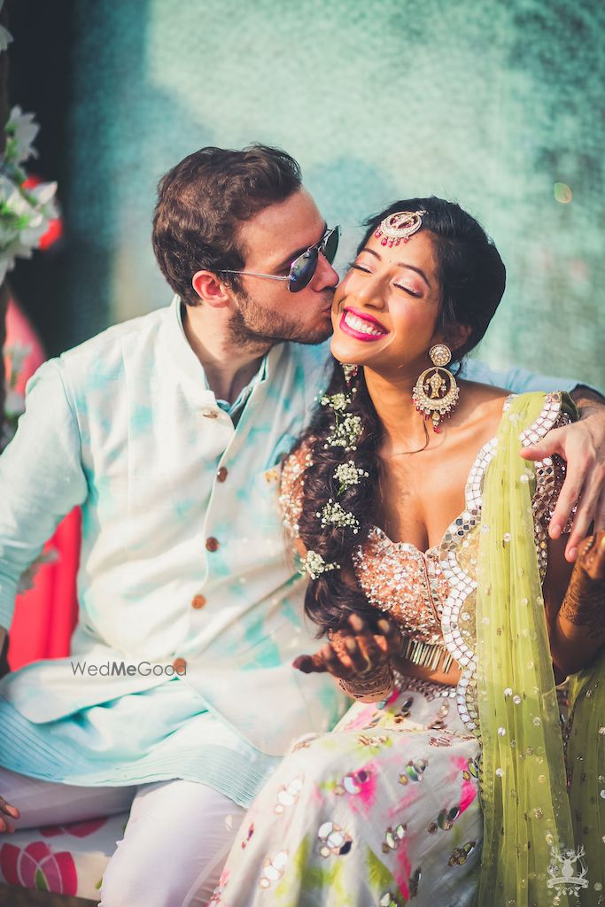 Photo of Mehendi couple portrait groom kissing bride shot