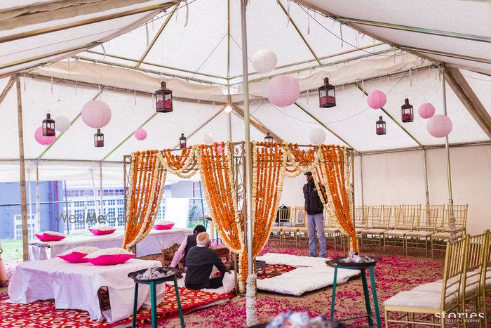 Photo of mandap with hanging pink lanterns