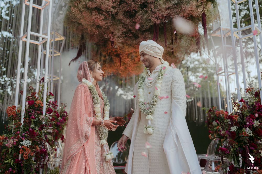 Photo of happy couple shot right after jaimala in pastels