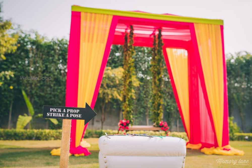 Photo of Orange photobooth backdrop with swing