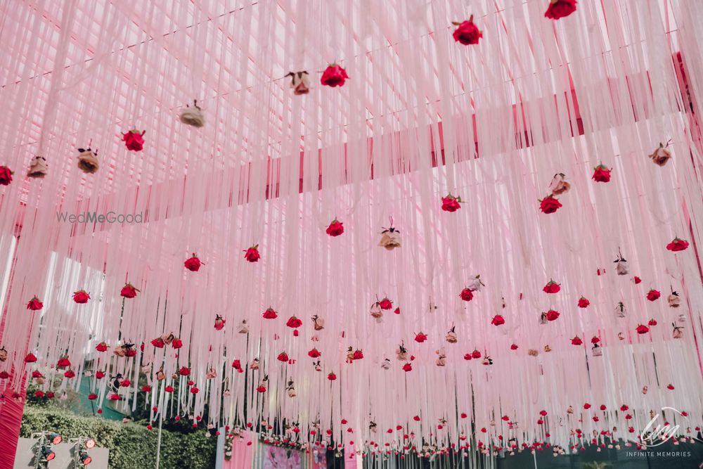 Photo of pretty mehendi decor for tent with pink florals