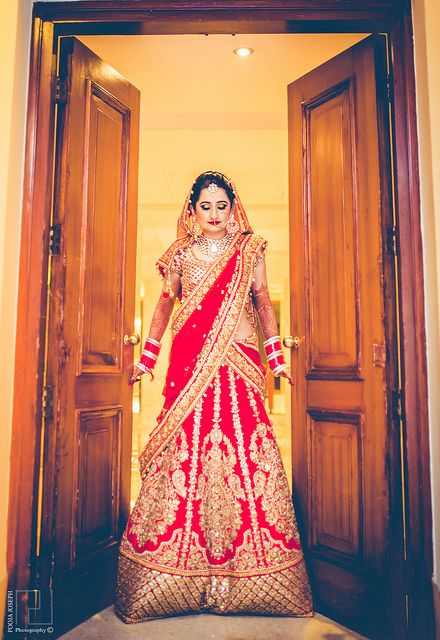 Photo of red and gold bridal lehenga