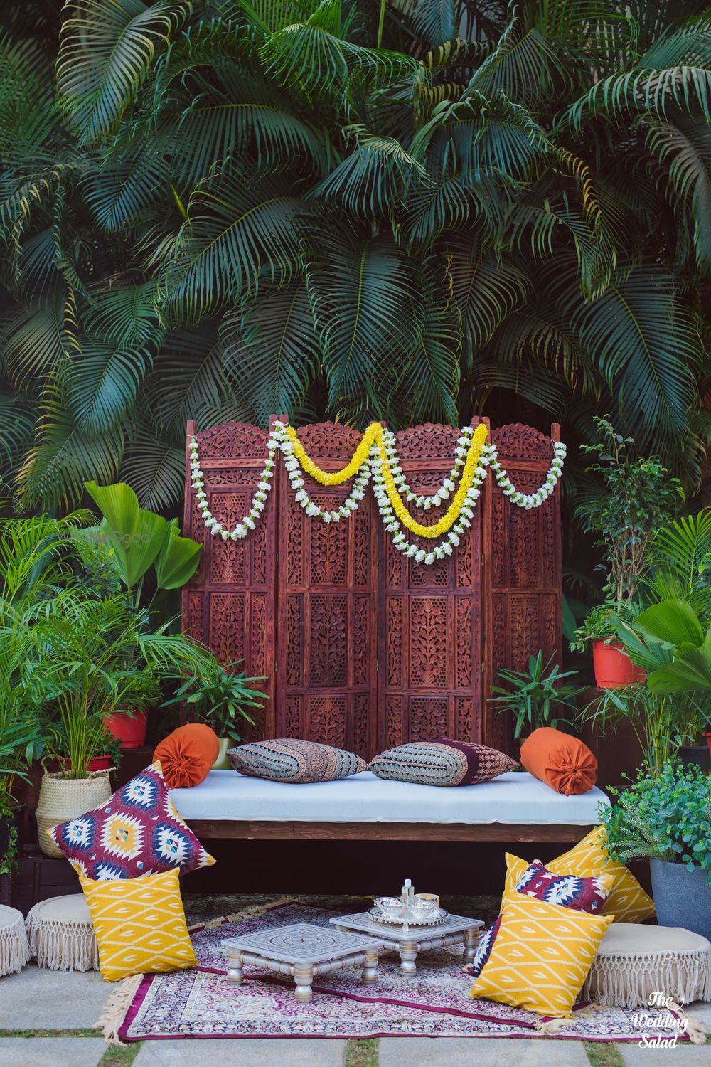 Photo of Haldi seating decor with white & yellow marigold flowers.