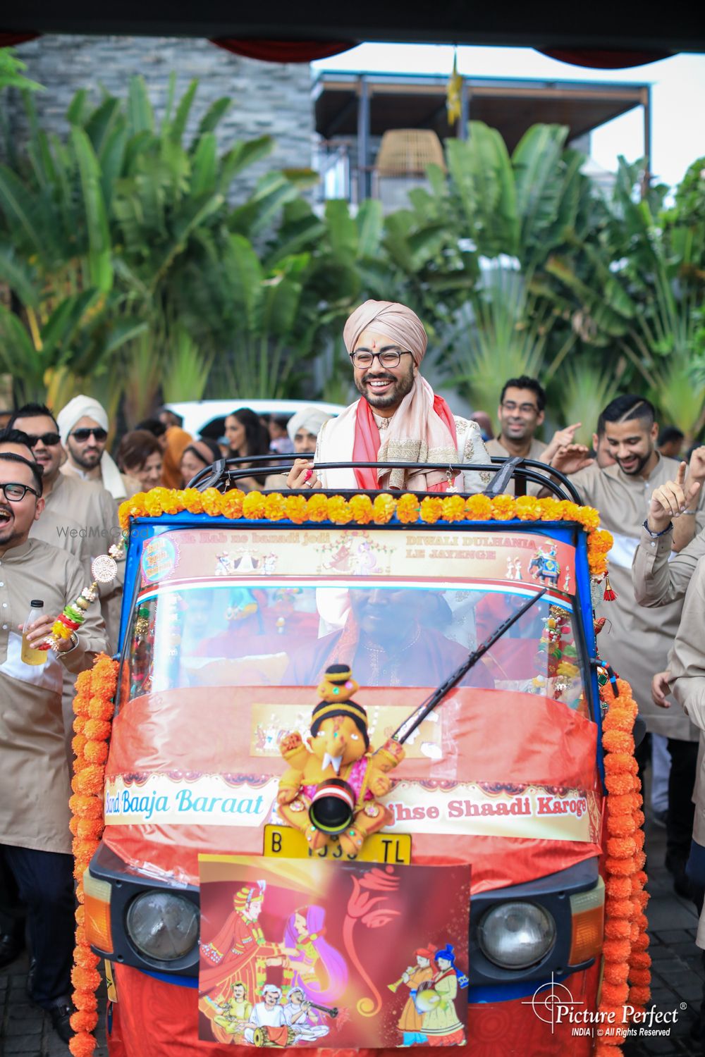 Photo of fun groom entry in an auto