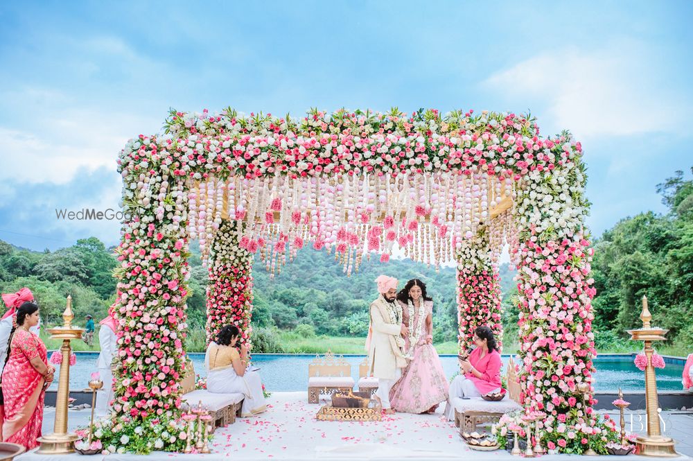 Photo of couple shot while taking pheras in mandap