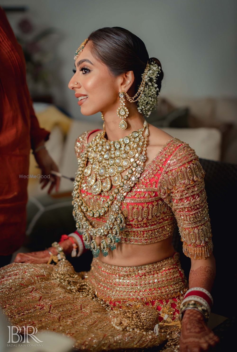 Photo of Red lehenga with heavy layered polki jewellery and earrings with Sahara