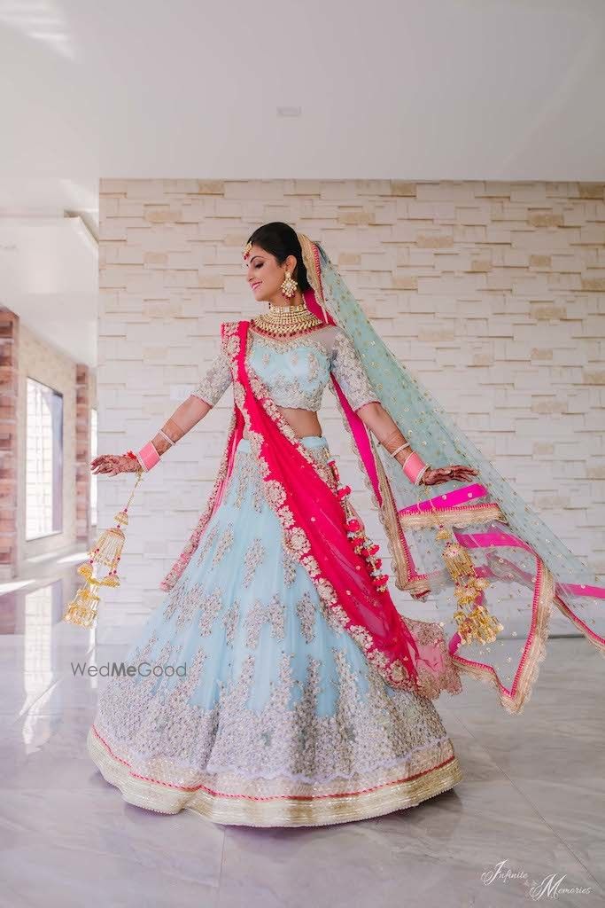 Photo of Twirling shot of a bride in powder blue lehenga.