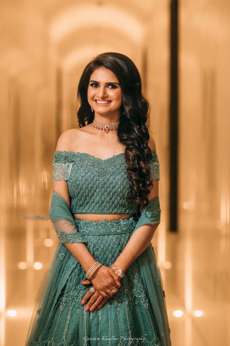 Photo of Off shoulder teal engagement lehenga