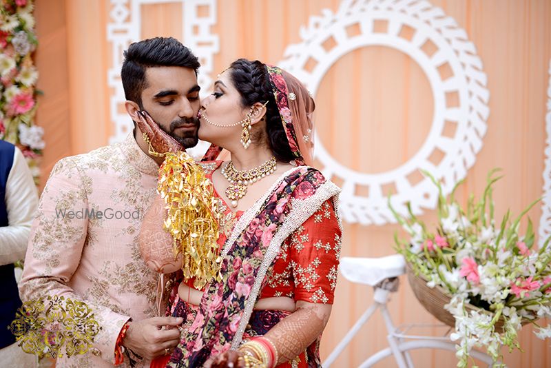 Photo of Bride giving kiss to groom at Indian wedding