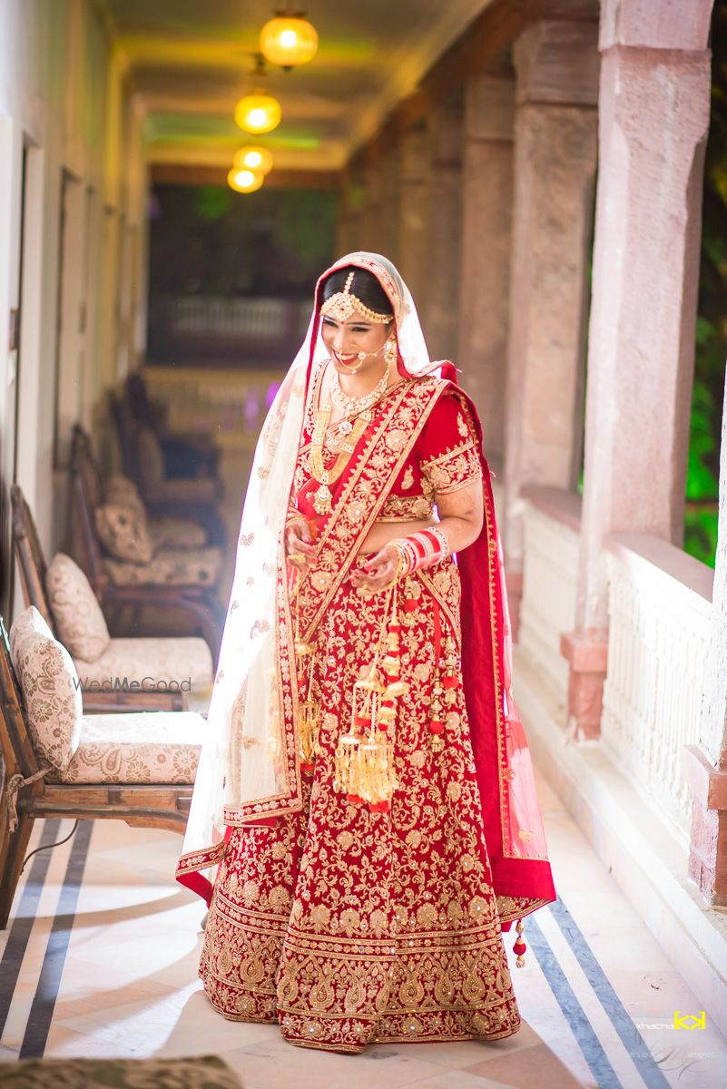 Photo of Bright Red and Gold Lehenga with Cream Dupatta