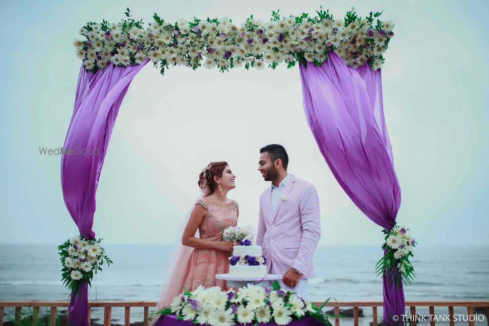 Photo of Couple portrait in destination wedding with purple drape backrop