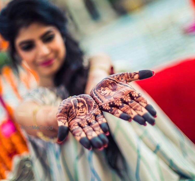 Photo of Bridal mehendi with portraits on display