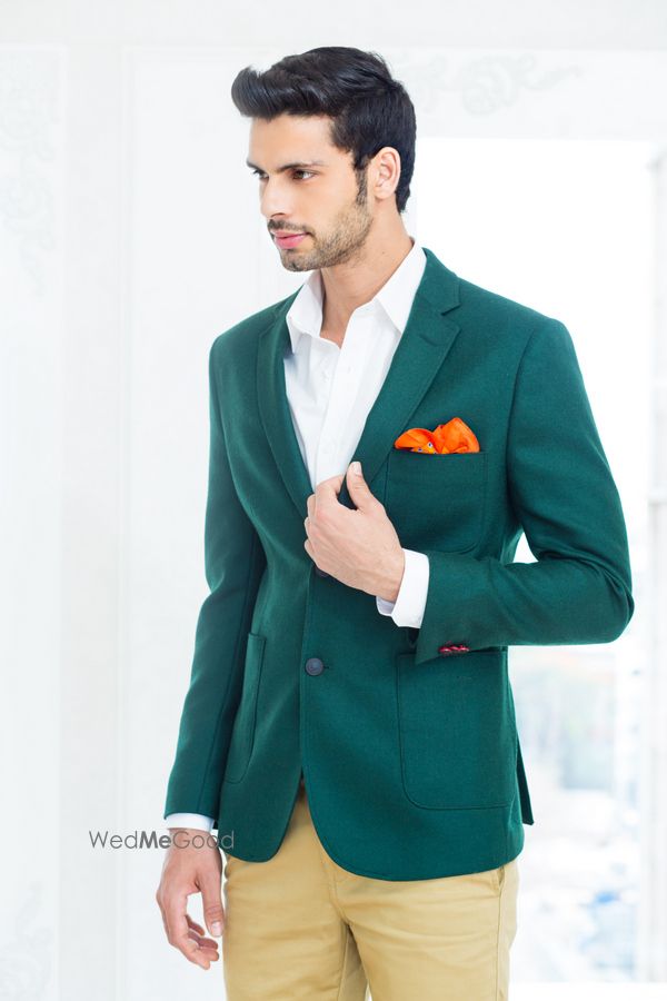 Photo of jade green aquamarine velvet jacket with tangerine orange hankerchief and beige pants