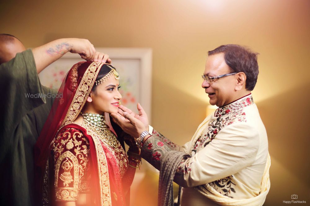 Photo of bride with father getting ready shot