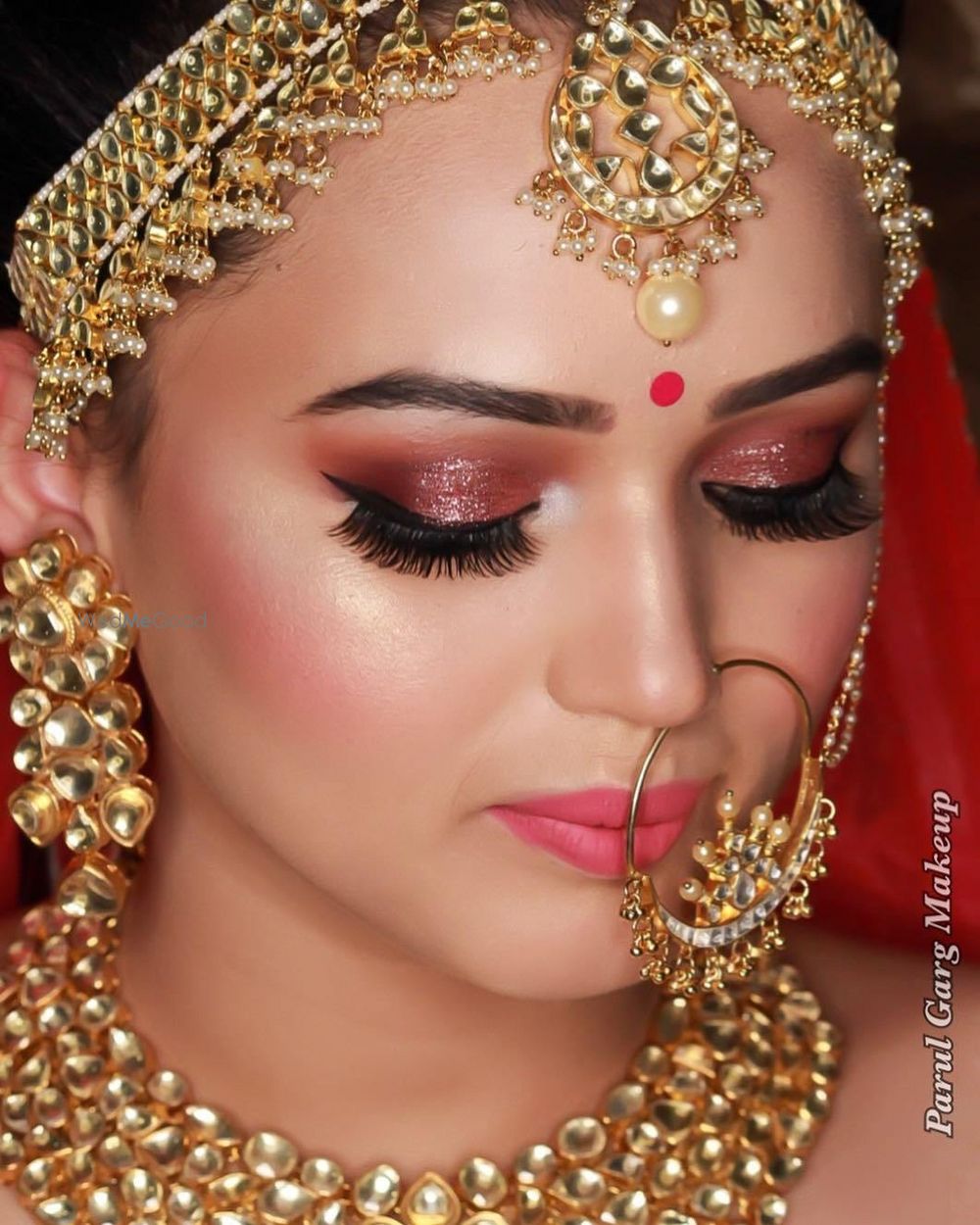 Photo of Beautiful dewy skin makeup with extended eyelashes and peach gold shimmer eyes with a lovely highlight