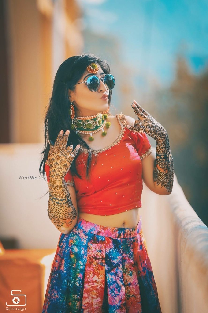 Photo of Cool bride shot on mehendi wearing glasses