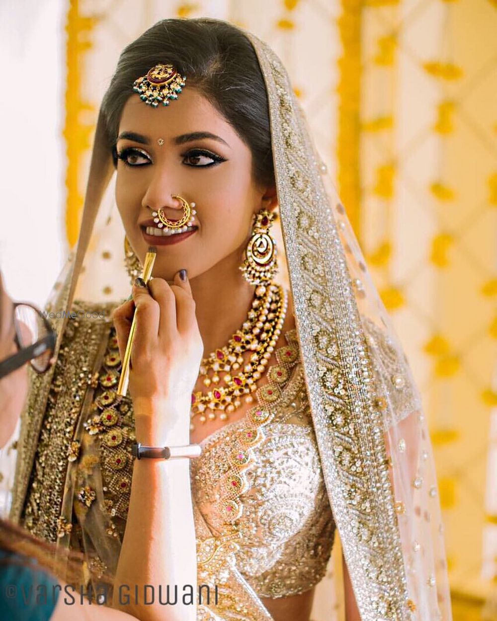 Photo of Bold bridal eye makeup with beige lehenga