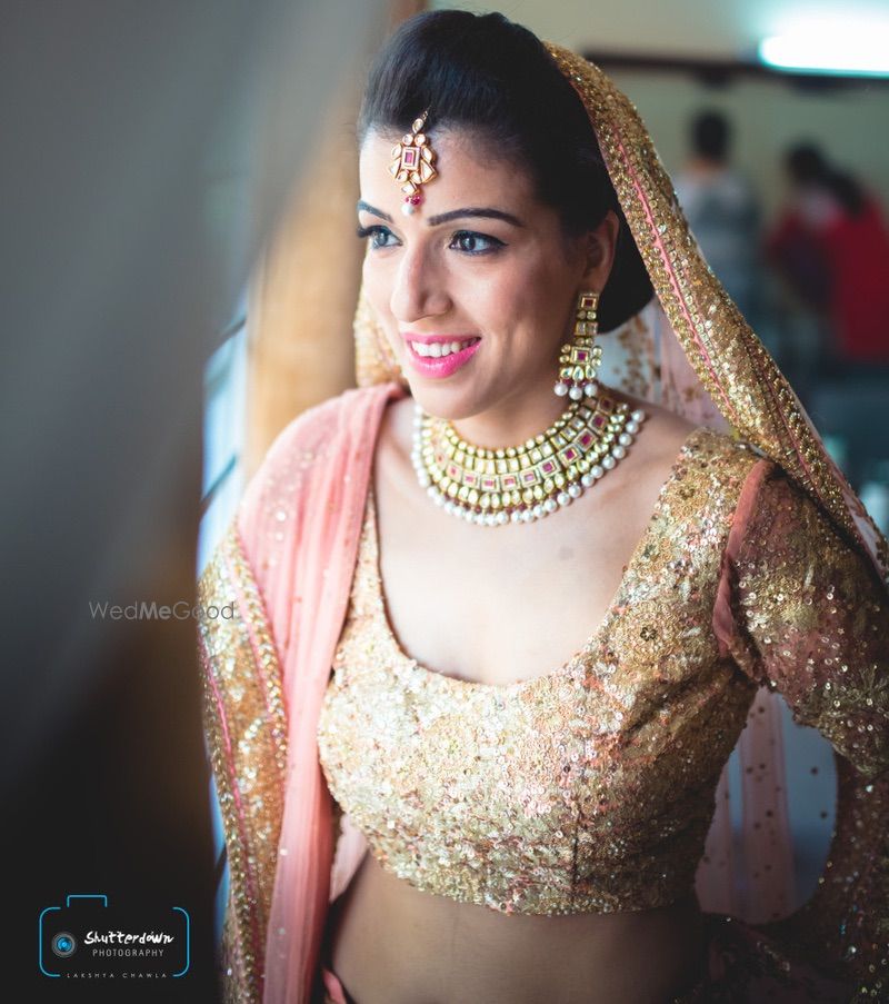 Photo of peach and gold lehenga